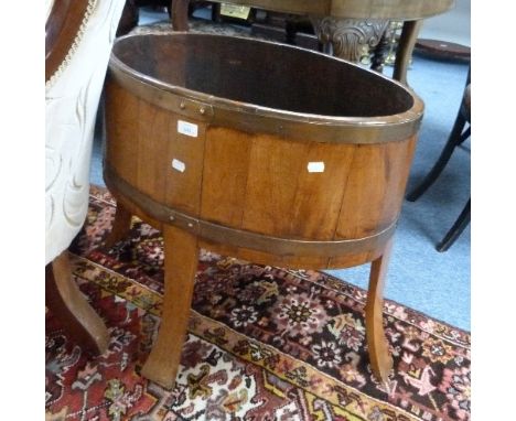 An oak and brass bound oval Planter, formerly a wine cooler.