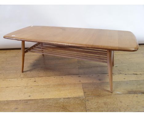 An Ercol light elm coffee table, the top 106 x 43 cmVarious scratches to top. Some staining. Large ring mark, Structurally so