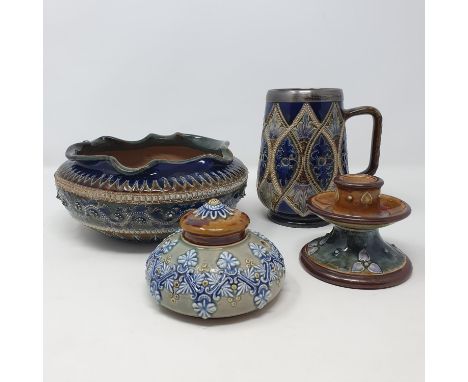 A Doulton Lambeth mug, decorated foliate forms, 14 cm high, a bowl, 20 cm diameter, a squat candlestick, 7 cm high, and an in