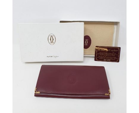 A Must de Cartier brown leather purse, 19 cm wide, boxedClasp button has corroded. No other faults found 