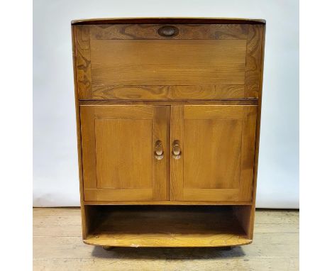 An Ercol cabinet, having a fall front above two cupboard doors above an open section, 110 x 82 cm 