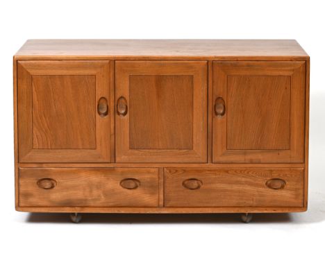 An Ercol sideboard, having three cupboard doors above two drawers, on castors, 131 cm wide76 cm high x 44 cm deep, some surfa