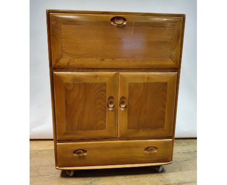 An Ercol elm cocktail cabinet, 82 cm wideOverall condition good. Light wear consummate with use. Slight variation of colour t