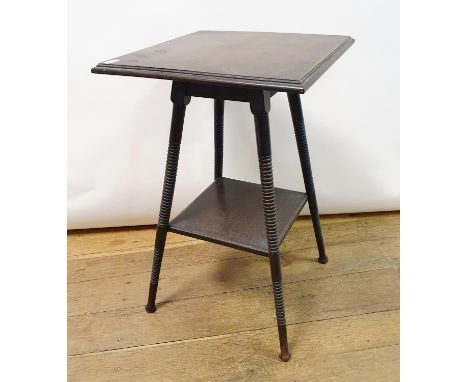An early 20th century walnut lamp table, on turned supports, 40 cm wideOne of the feet has a large piece off and has been rep