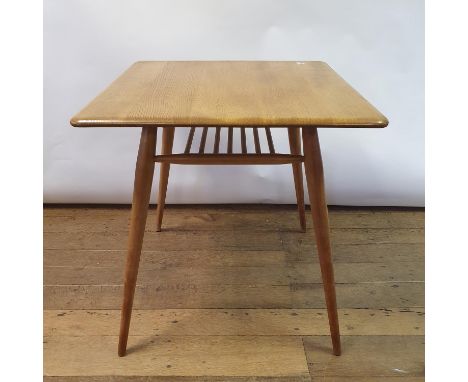 An Ercol light elm kitchen table, 73 cm high 70 cm wideLight wear, some scratches to top due to use. Various scull marks to l