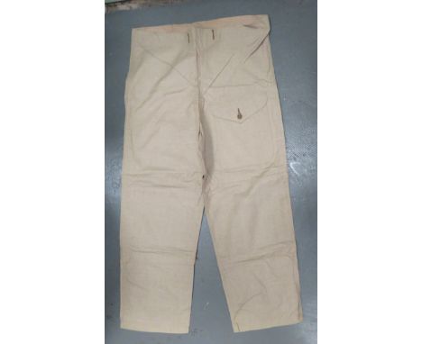 WW2 Dated Khaki Over Trousers light khaki tan, cotton, wide leg, over trousers. &nbsp;Front of left leg with large patch pock