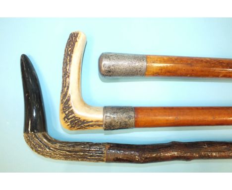 A horn-handled silver-mounted walking stick, 90cm, one other horn-handled walking stick and a silver-mounted walking cane, (3