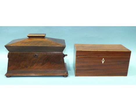 A sarcophagus-shaped mahogany tea caddy, the hinged lid revealing three lidded tea canisters, one handle lacking, 36cm wide, 