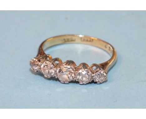 A five-stone diamond ring claw-set five graduated old brilliant-cut diamonds, in 18ct yellow gold and platinum mount, size K,