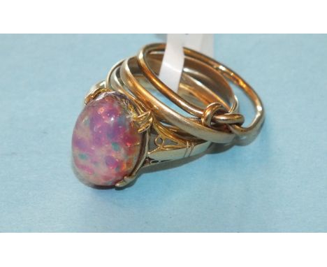 A 9ct gold knot ring, size M½, 1.3g, an unmarked Russian wedding ring, size L and a 9ct gold ring set opaline glass, size K, 