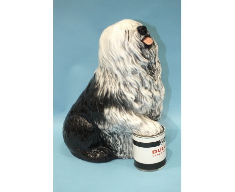A 1960's Beswick ceramic advertising figure for Dulux Paints, depicting an Old English Sheepdog with his paw resting on a tin