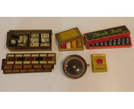 A collection of vintage and antique games. Including a miniature spring mechanism roulette wheel, a set of 'Lucky Chips' nude