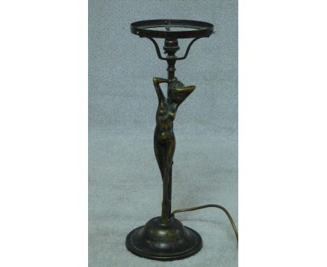 An Art Nouveau style brass and copper stretching nude lady table lamp on circular base. Stamped MOD DEP. H.43cm 