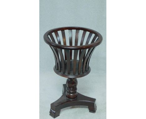 A 19th century style teak jardiniere stand with shaped slatted sides on carved tripod platform base. H.70cm 