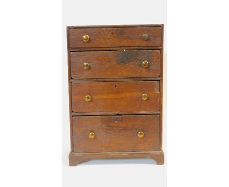 A Georgian oak apprentice piece chest of four drawers on bracket feet. H.46 W.31 D.18cm 