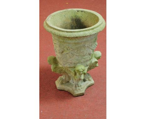 An urn shaped garden planter supported by winged caryatid on lion paw feet on shaped platform base. H.52 W.36cm 