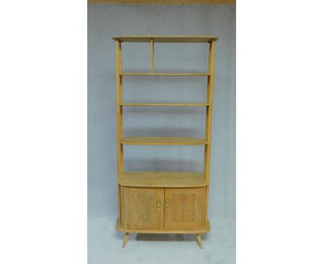 A vintage Ercol blonde elm "Giraffe" room divider, model 363, with four open tiers above base drawer on splay supports, H.190