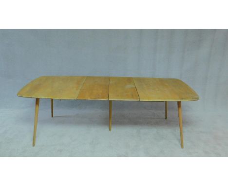 A vintage Ercol blonde elm and beech dining table with extra leaf. H.70 W.240 D.77cm 