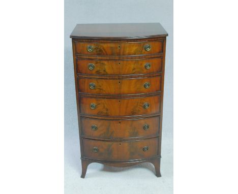 A Georgian style flame mahogany bowfronted narrow chest of six graduating drawers on swept bracket feet. H.109 W.62 D.49cm 