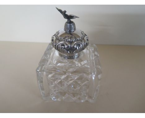 A large glass inkwell with silver embossed top surmounted by a bird - London 1900/01 - Maker JG&S - 16 cm tall x 11 cm x 11 c