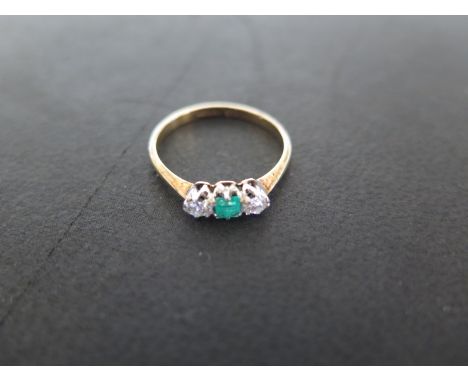 An 18ct yellow gold diamond and emerald three stone ring - size N - approximately 1.5 grams - emerald approximately 3mm squar