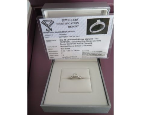 An 18ct white gold diamond ring with a central stone - approx weight 0.37ct - having eight small side stones - ring size J - 