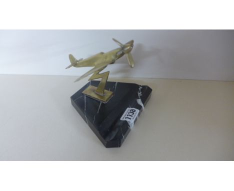 An Art Deco brass and marble desk stand model of a Spitfire aeroplane, the base approx 15.5 cm x 12 cm