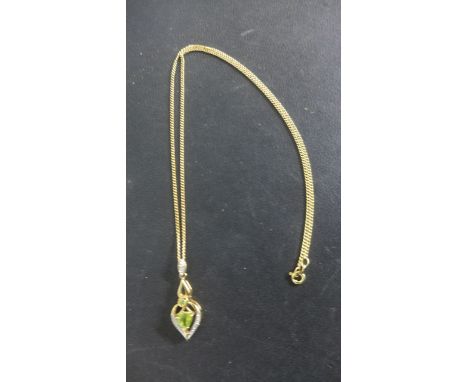 A 9ct Gold Peridot and Diamond Pendant on a 46 cm chain - pendant 3 cm long - approximately 4.5 grams - in good condition