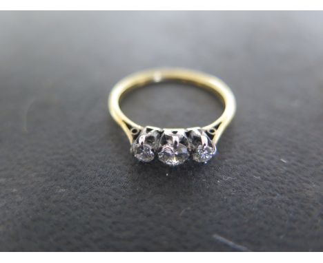 A 18ct yellow gold three stone diamond ring size N - approx weight 1.9 grams - central diamond approx 0.18ct - some usage but