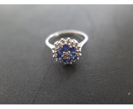 An 18ct white gold diamond and sapphire cluster ring - size M/N - approximately 3.5 grams - approximately 11mm diameter - ove