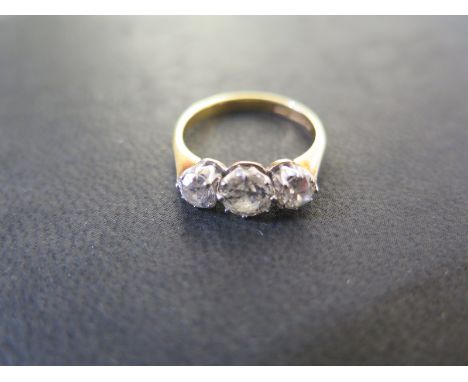 An 18ct Yellow Gold three stone Diamond Ring - size K-L, approx 3.4 grams, the central stone approx 0.65ct, flanked by two ap