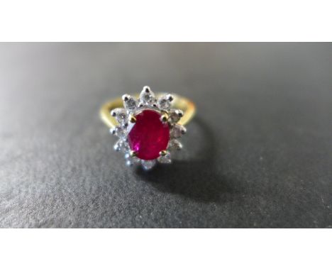 An 18ct Yellow Gold Ruby and Diamond Cluster Ring - size K, approximately 4 grams - centre ruby approximately 7.7 mm x 6 mm x