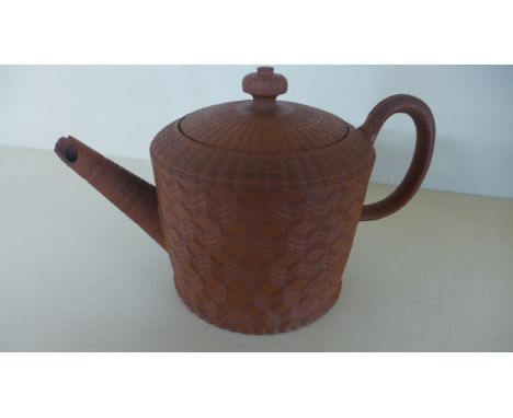 An 18th Century red ware tea-pot and cover, the cylindrical body engine turned with chevrons and the cover with wavy reeded b