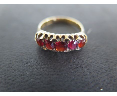 An 18ct yellow gold garnet five stone ring size M - approx weight 4.5 grams - some usage wear, generally good