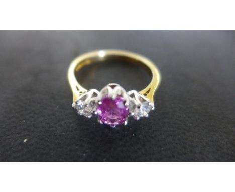 An 18ct Yellow Gold Ruby and Diamond Ring, Size P, approx 3.6 grams, the central approx 1.29ct, Ruby flanked by two 0.36ct Di