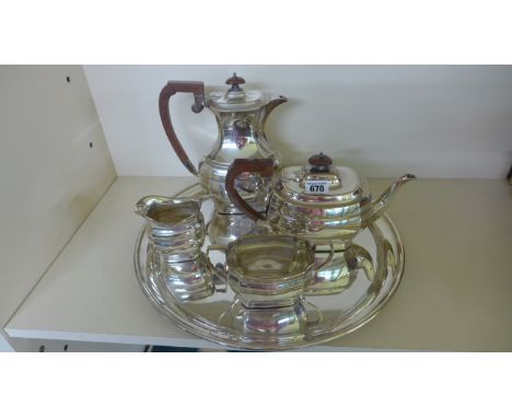 A silver plated tea service consisting tea pot, coffee pot, milk, sugar and circular serving tray