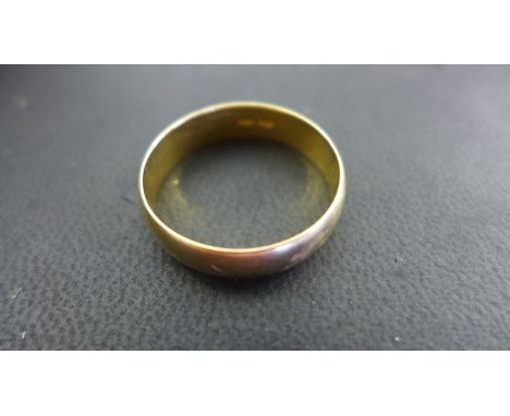 An 18ct yellow gold band ring - size W, approx 3.4 grams - some usage marks