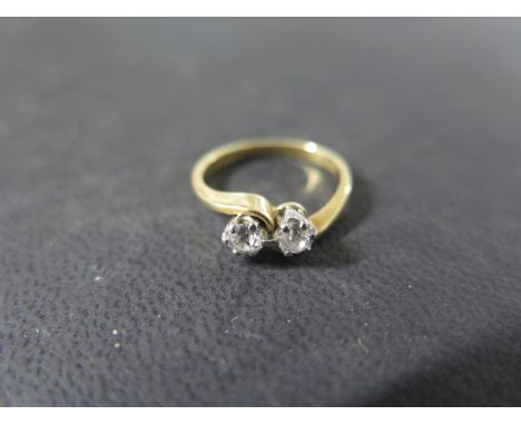 An 18ct yellow gold two stone diamond crossover ring - each diamond approx 0.15ct - ring size J - weight approx 2.7 grams - g