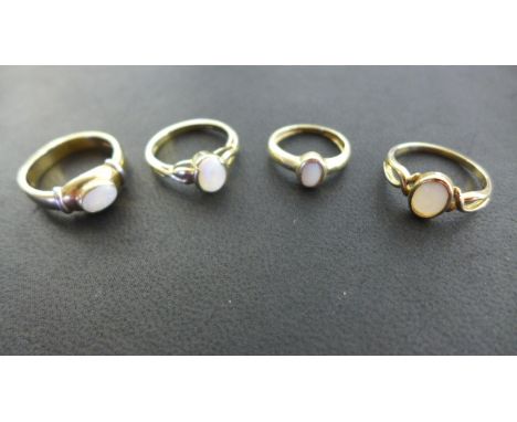 Four 9ct Yellow Gold Opal Rings - ranging in size from G to Q - approximate total weight 10.8 grams - all good condition