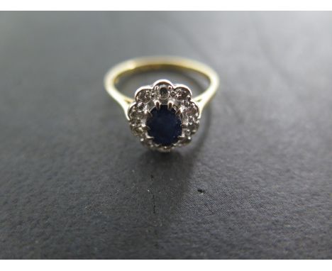 An 18 ct yellow gold sapphire and diamond cluster ring - size M - approximately 2.8 grams - cluster approximately 10mm x 11mm