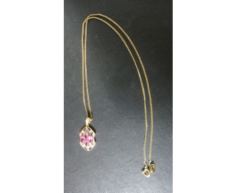 A 9ct gold spinel and diamond pendant on a 46 cm long chain - pendant 2.5 cm long - approx 4.5 grams