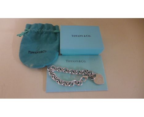 A silver Tiffany chain link bracelet with heart shaped return token - in good clean condition - some very light usage wear