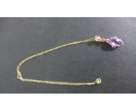 A 9ct Gold Amethyst Diamond and Ruby Pendant on a 40 cm chain - pendant is 3 cm long - approximate weight 2.8 grams - in good