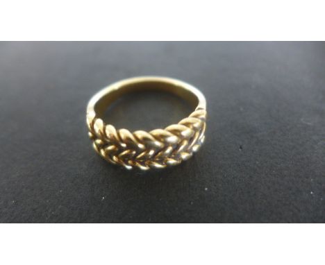 A Gold Rope Twist Ring - Size R - tests to approximately 18ct - approximately 9 grams - not hallmarked - some usage marks, bu