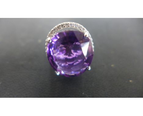 An 18ct White Gold Ring with a fine imperial amethyst to shoulder, approx 20.83cts surrounded by 52 diamonds, approx 0.64cts 