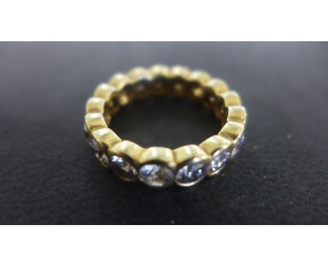 An 18ct Yellow Gold Eternity Ring set with seventeen  diamonds each approx 0.25 ct, size H, approx 8 grams - surface scratche