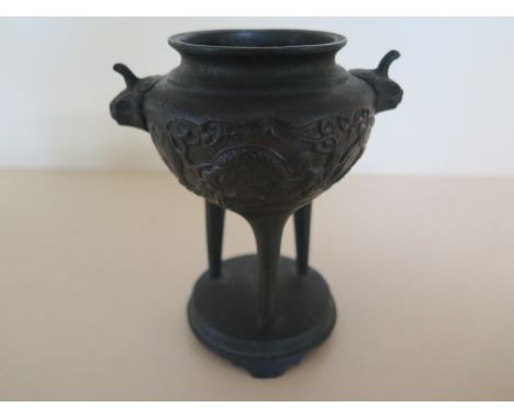 An Oriental Bronze Dragon Censor on three supports - 12.5cm tall - in good condition