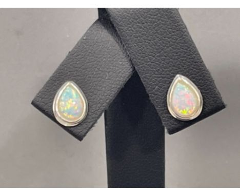 A pair of silver and opal pear shaped earrings