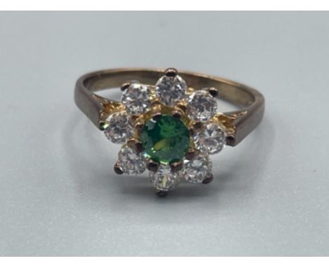 Ladies 9ct gold green stone cluster ring. Comprising of green centre stone surrounded by 8 CZ all claw set 2.46g size K1/2