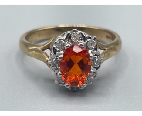 Ladies 9ct gold fire opal and diamond cluster ring, comprising of oval centre stone surrounded by 8 round brilliant cut diamo